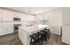 Kitchen featuring stainless appliances, white cabinets, a large island, and a window for natural light at 175 Strada Fontana, Henderson, NV 89011