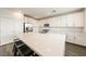 Modern kitchen featuring white cabinets, stainless steel appliances, and a large center island with seating at 175 Strada Fontana, Henderson, NV 89011