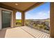 Exterior view of a covered balcony showcasing wrought iron railing and expansive views at 175 Strada Fontana, Henderson, NV 89011