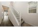Hallway and staircase featuring neutral décor with a modern railing, window, and wood-look flooring at 175 Strada Fontana, Henderson, NV 89011