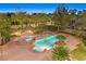 Aerial view of a backyard with a multi-tiered pool, spa, and well-maintained landscaping at 1809 White Hawk Ct, Las Vegas, NV 89134