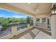 Spacious balcony with wrought iron railing overlooking green backyard with mature trees at 1809 White Hawk Ct, Las Vegas, NV 89134