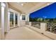 Balcony at dusk with wrought iron railing overlooking green backyard with mature trees at 1809 White Hawk Ct, Las Vegas, NV 89134