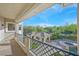 Spacious balcony with wrought iron railing overlooking green backyard and a pool at 1809 White Hawk Ct, Las Vegas, NV 89134