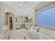 Elegant bathroom featuring a luxurious tub, double sinks, and marble countertops at 1809 White Hawk Ct, Las Vegas, NV 89134