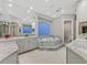 Elegant bathroom featuring a luxurious tub, double sinks, and marble countertops at 1809 White Hawk Ct, Las Vegas, NV 89134