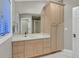 Well-lit bathroom with a large mirror, double sink vanity, and ample cabinet space at 1809 White Hawk Ct, Las Vegas, NV 89134