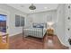Bedroom featuring hardwood floors, a ceiling fan, and balcony access at 1809 White Hawk Ct, Las Vegas, NV 89134