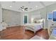 Bedroom featuring hardwood floors, a ceiling fan, and a painted brick wall at 1809 White Hawk Ct, Las Vegas, NV 89134