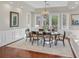 This dining room features hardwood floors, elegant lighting, and large windows with backyard views at 1809 White Hawk Ct, Las Vegas, NV 89134