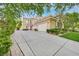 Exterior view showcasing a long driveway leading to the home's facade and attached garage at 1809 White Hawk Ct, Las Vegas, NV 89134