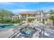 Expansive backyard with a pool, spa, mature trees, and a luxurious home, creating an ideal space for recreation at 1809 White Hawk Ct, Las Vegas, NV 89134