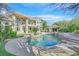 An amazing view showcasing a large backyard, pool, spa, and lush landscaping creating a private retreat at 1809 White Hawk Ct, Las Vegas, NV 89134