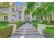 Elegant home with a landscaped front yard, walkway leading to a double-door entrance, and large windows at 1809 White Hawk Ct, Las Vegas, NV 89134