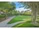 Scenic green space featuring a lush lawn, mature trees, sidewalk, and a charming gazebo in the distance at 1809 White Hawk Ct, Las Vegas, NV 89134