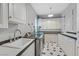 Convenient laundry room with modern machines, a sink, and ample storage cabinets at 1809 White Hawk Ct, Las Vegas, NV 89134