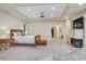 Large main bedroom featuring a fireplace, ensuite, and tray ceiling at 1809 White Hawk Ct, Las Vegas, NV 89134