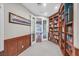 Elegant office with rich wood paneling, built-in bookcases, and frosted glass doors at 1809 White Hawk Ct, Las Vegas, NV 89134