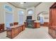 Beautiful office featuring custom wood built-ins, a fireplace, and large windows at 1809 White Hawk Ct, Las Vegas, NV 89134