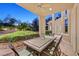 Covered patio with large dining table and seating, perfect for enjoying outdoor meals with lush green surroundings at 1809 White Hawk Ct, Las Vegas, NV 89134