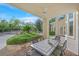 Covered patio with a large dining table, offering a beautiful view of the lush landscaping and pool area at 1809 White Hawk Ct, Las Vegas, NV 89134