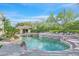 Large pool area with inviting pool, spa, lush landscaping, and a serene setting for relaxing or entertaining at 1809 White Hawk Ct, Las Vegas, NV 89134