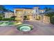 Stunning backyard oasis featuring a pool, spa, and a luxurious outdoor living space at 1809 White Hawk Ct, Las Vegas, NV 89134
