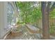 View of the side yard with raised garden bed, mature trees and sunlight shining through the leaves at 1809 White Hawk Ct, Las Vegas, NV 89134