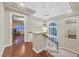 Upper-level hallway with hardwood floors, staircase and a decorative chandelier, creating a bright and airy space at 1809 White Hawk Ct, Las Vegas, NV 89134