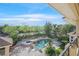 Aerial view of a sparkling swimming pool and spa surrounded by lush landscaping and mature trees at 1809 White Hawk Ct, Las Vegas, NV 89134
