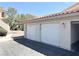 Detached garages available with white doors and a clear parking area and easy access at 1881 W Alexander Rd # 2129, North Las Vegas, NV 89032