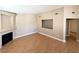 Cozy living room with hardwood floors, neutral paint, a fireplace, and an open doorway to another room at 1881 W Alexander Rd # 2129, North Las Vegas, NV 89032