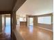 Spacious living room area featuring hardwood floors, natural light, neutral paint, and an open floor plan at 1881 W Alexander Rd # 2129, North Las Vegas, NV 89032