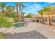 Enjoy a desert paradise with a beautiful pool and mature landscaping, including palm trees at 1913 Madagascar Ln, Las Vegas, NV 89117
