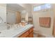 Cozy bathroom features a white tiled countertop with a single sink and tiled shower at 1913 Madagascar Ln, Las Vegas, NV 89117
