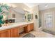 Spacious bathroom with double sinks, a vanity, a stand-up shower, and a decorative mirror at 1913 Madagascar Ln, Las Vegas, NV 89117