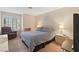 Cozy bedroom with a queen bed, natural light, and a lounge chair at 1913 Madagascar Ln, Las Vegas, NV 89117
