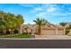 Lovely single-story home boasting a two-car garage, tile roof, desert landscaping and mature palms at 1913 Madagascar Ln, Las Vegas, NV 89117