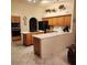Traditional kitchen with oak cabinetry, white countertops and tile flooring at 1913 Madagascar Ln, Las Vegas, NV 89117
