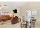 Open living room features a fireplace, media center, and dining area with bright natural light at 1913 Madagascar Ln, Las Vegas, NV 89117
