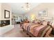 The main bedroom features a fireplace, a ceiling fan, and natural light at 1913 Madagascar Ln, Las Vegas, NV 89117