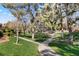 Green community space with curving path and trees on a sunny day at 1913 Madagascar Ln, Las Vegas, NV 89117