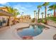 Private backyard oasis with pool, rock accents and mature palm trees for shade at 1913 Madagascar Ln, Las Vegas, NV 89117