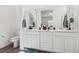 Bright bathroom featuring double sinks, a toilet, and ample counter space at 209 Bellini Peak Ave, Henderson, NV 89011