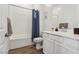 Bathroom with shower and tub combination, white subway tile and a single sink vanity at 209 Bellini Peak Ave, Henderson, NV 89011