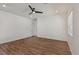 Spacious bedroom featuring a ceiling fan, wood-look flooring, and plenty of natural light at 209 Bellini Peak Ave, Henderson, NV 89011