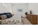 Brightly lit bedroom with a comfortable bed, carpet flooring, and a dresser at 209 Bellini Peak Ave, Henderson, NV 89011