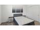Clean bedroom features a bed with matching end tables and simple artwork on the wall at 209 Bellini Peak Ave, Henderson, NV 89011