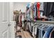 Walk-in closet with ample storage, hanging rods, and built-in shelving units at 209 Bellini Peak Ave, Henderson, NV 89011