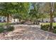 Picturesque courtyard with mature trees, manicured landscaping, and a brick-paved walkway leading to the building at 209 Bellini Peak Ave, Henderson, NV 89011